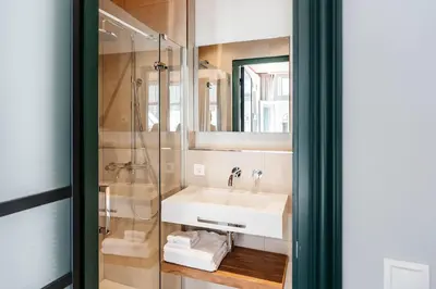 a bathroom with a sink and a shower at Cozy Pillow in Utrecht