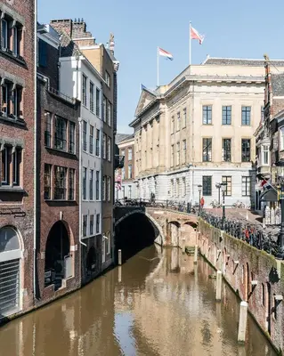 a river in a city with buildings and a bridge at Cozy Pillow in Utrecht