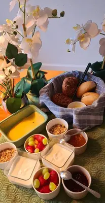 a table topped with trays of food and bowls of dips at LandLust Guesthouse B&B Amsterdam Area Purmerend in Purmerend