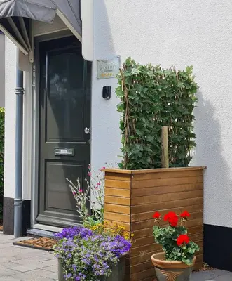 a house with flowers in front of a door at LandLust Guesthouse B&B Amsterdam Area Purmerend in Purmerend