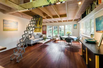a living room with a spiral staircase in a loft at Unique Atelier in Bergen in Bergen