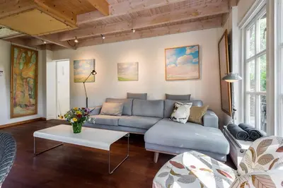 a living room with a blue couch and a table at Unique Atelier in Bergen in Bergen