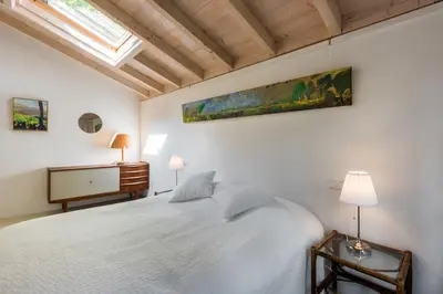 a bedroom with a large white bed and a skylight at Unique Atelier in Bergen in Bergen