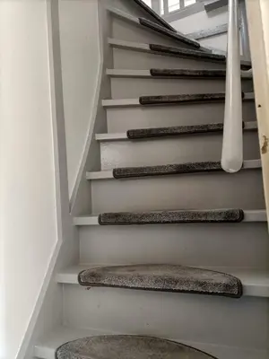 a staircase in a house with a rug at Pension Schier in Zandvoort