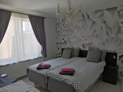 a bedroom with a bed with two pillows on it at Pension Schier in Zandvoort