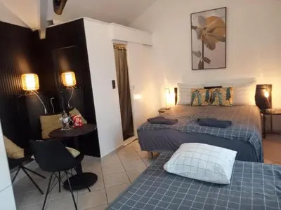 a bedroom with two beds and a table and chairs at Pension Schier in Zandvoort