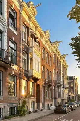 a row of brick buildings on a city street at Amstel Corner Hotel in Amsterdam