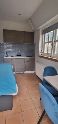 a room with a kitchen with a table and chairs at Near the Beach in Zandvoort