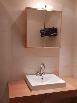 a bathroom with a sink and a mirror at Near the Beach in Zandvoort