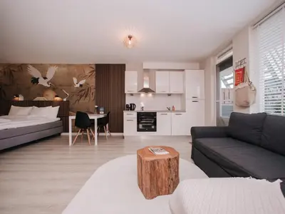 a living room with a couch and a table at Casa del Mar Zandvoort in Zandvoort