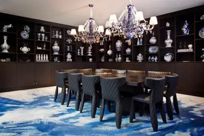 a dining room with a table and chairs and chandeliers at Andaz Amsterdam, Prinsengracht, By Hyatt in Amsterdam