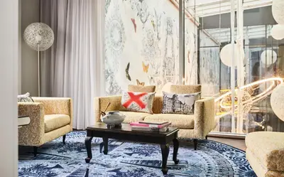 a living room with a couch and a coffee table at Andaz Amsterdam, Prinsengracht, By Hyatt in Amsterdam