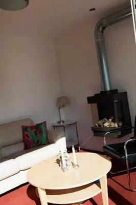 a living room with a couch and a table at Appartementen Bergen aan Zee de Schelp in Bergen aan Zee