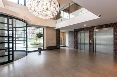 a large lobby with a large chandelier at XO Hotels Park West in Amsterdam