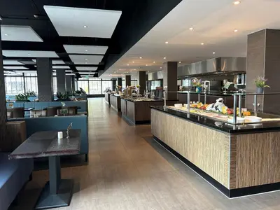 a restaurant with a buffet line in a cafeteria at XO Hotels Park West in Amsterdam