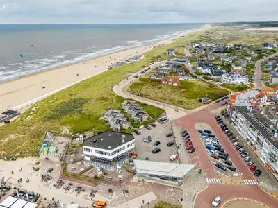 an aerial view of a city and the beach at Neptunus Appartementen in Bergen aan Zee
