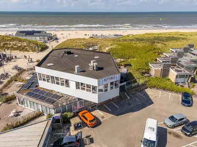 an aerial view of a house next to the beach at Neptunus Appartementen in Bergen aan Zee