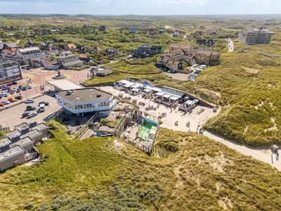 an aerial view of a city with a parking lot at Neptunus Appartementen in Bergen aan Zee