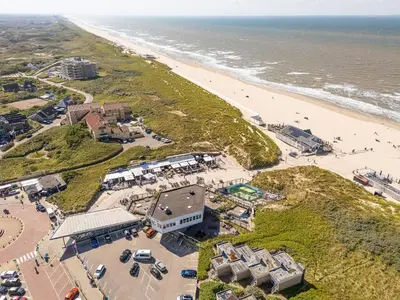 an aerial view of a beach and a building at Neptunus Appartementen in Bergen aan Zee