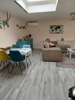 a living room with a couch and a table at JaBaKi Garden House in Hoofddorp