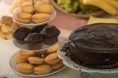 a table with three tiers of cupcakes and a chocolate cake at B&B Gabriela Amsterdam in Amsterdam