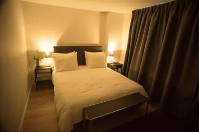 a bedroom with a bed with white sheets and pillows at B&B Gabriela Amsterdam in Amsterdam