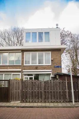 a house with a wooden fence in front of it at B&B Gabriela Amsterdam in Amsterdam