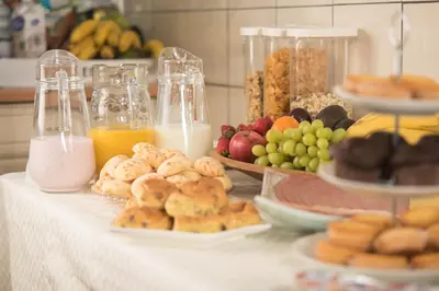 a table topped with plates of food and drinks at B&B Gabriela Amsterdam in Amsterdam