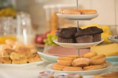 a three tiered display of cupcakes and muffins on a table at B&B Gabriela Amsterdam in Amsterdam
