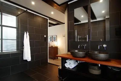 a bathroom with two sinks and a mirror at 1637: Historic Canal View Suites in Amsterdam