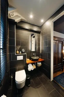 a bathroom with a toilet and a sink at 1637: Historic Canal View Suites in Amsterdam