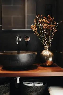 a bathroom with a sink and a vase with flowers at 1637: Historic Canal View Suites in Amsterdam