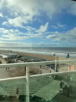 a view of a beach and the ocean from a building at Studio Maxime in Zandvoort