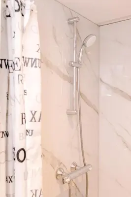 a shower in a bathroom with a shower curtain at Studio Maxime in Zandvoort