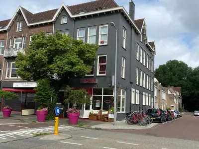a building on a street with bikes parked in front of it at Hotel Isis in Amsterdam