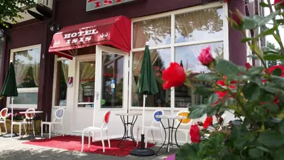 a restaurant with tables and chairs in front of a building at Hotel Isis in Amsterdam