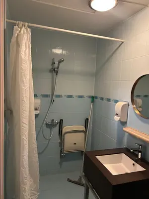 a bathroom with a shower and a sink at Hotel Isis in Amsterdam