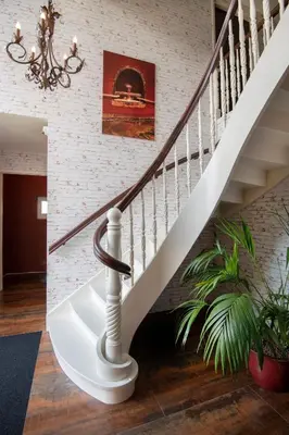 a staircase in a home with a chandelier at Villa Braas in Breukeleveen