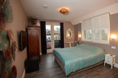 a bedroom with a bed and a large window at Villa Braas in Breukeleveen