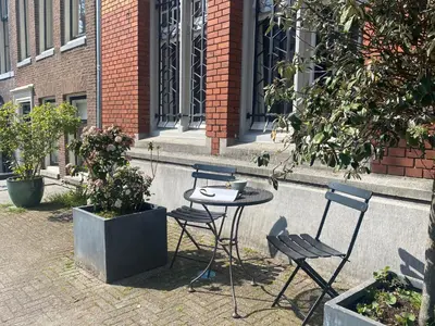a table and chairs sitting in front of a building at Amstel Boutique Studio in Amsterdam