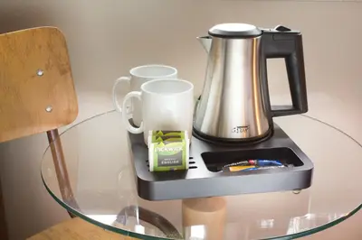 a glass table with a coffee maker and cups on it at Best Western Zaan Inn, Amsterdam - Zaandam in Zaandam