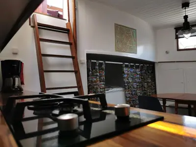 a kitchen with a table and a dining room at Waterloo square river vieuw houseboat in Amsterdam