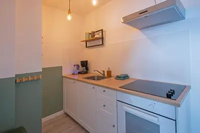 a kitchen with a sink and a counter top at Amsterdam Beach Apartment 90 in Zandvoort