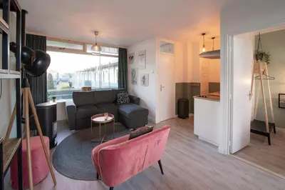 a living room with a couch and a table at Amsterdam Beach Apartment 90 in Zandvoort