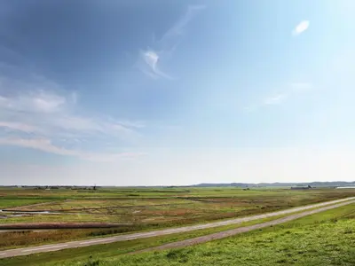 a dirt road in the middle of a field at Villa in Schoorldam with Garden in Schoorldam