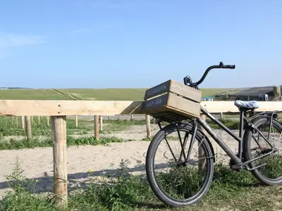 a bike with a box on it parked next to a fence at Villa in Schoorldam with Garden in Schoorldam