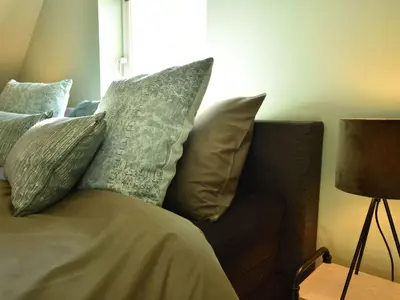 a couch with pillows on it in a room at Villa in Schoorldam with Garden in Schoorldam