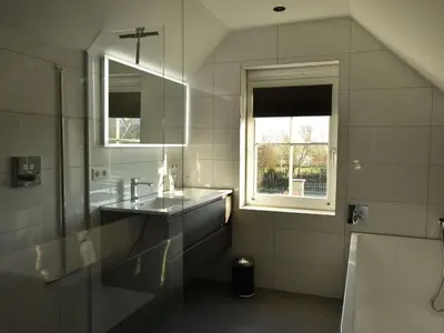 a bathroom with a sink and a window at Villa in Schoorldam with Garden in Schoorldam