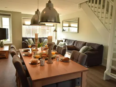 a living room with a table and a couch at Villa in Schoorldam with Garden in Schoorldam