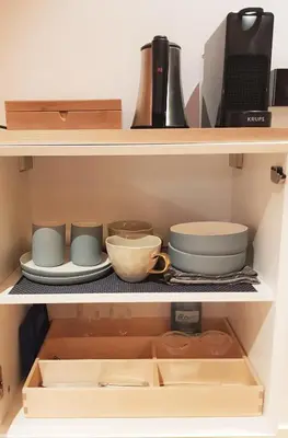 a shelf with bowls and other kitchen utensils at 23 SouS in Amsterdam